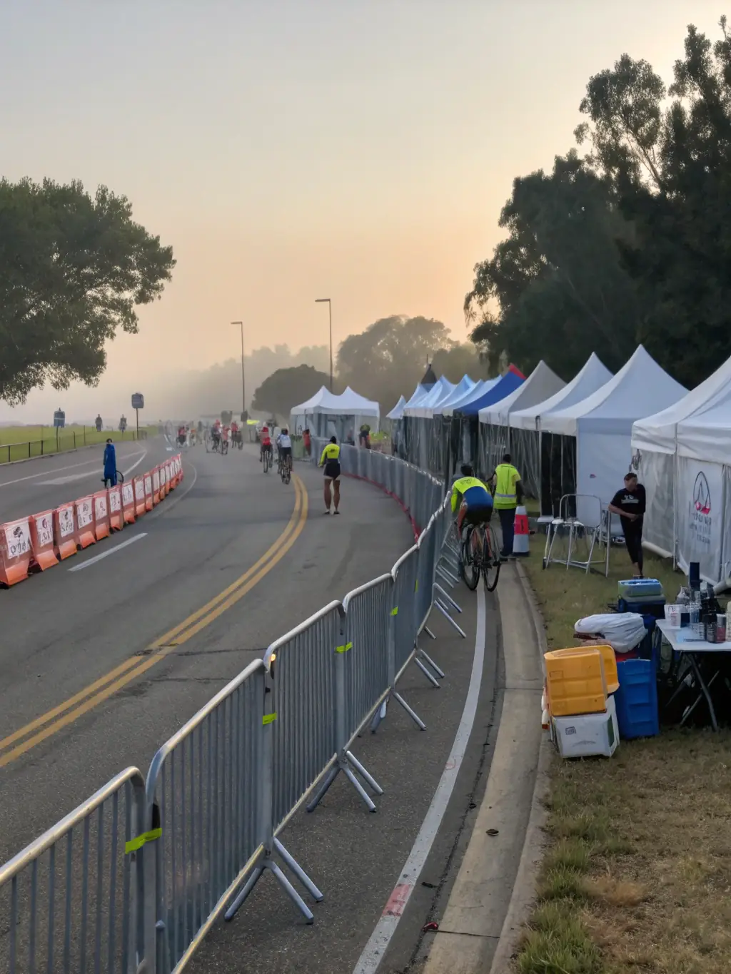 A photo of volunteers setting up the race course, highlighting the community involvement and support behind CRITERIUMS EXPERIENCE events.